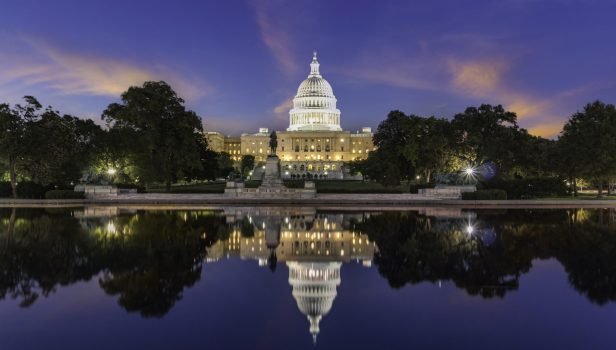 The United States Capitol Building, seen from reflection pool on dusk. Washington DC, USA.